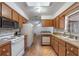Galley kitchen features a window over the sink and tile flooring at 3199 Tobago Ct, Apopka, FL 32703