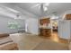 Bright living room featuring carpet flooring, ceiling fans, and a view into the kitchen at 3199 Tobago Ct, Apopka, FL 32703