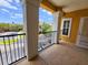 A lovely balcony view from a condo features black iron railings and stucco columns, offering ample outdoor space at 3577 Conroy Rd # 331, Orlando, FL 32839