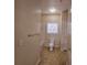 Cozy bathroom featuring a toilet, window, and neutral tile flooring at 3577 Conroy Rd # 331, Orlando, FL 32839