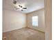 Bedroom featuring neutral carpet, a ceiling fan, and a window overlooking the exterior at 3577 Conroy Rd # 331, Orlando, FL 32839