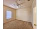 Cozy bedroom with neutral carpet, a ceiling fan, and a window overlooking the exterior at 3577 Conroy Rd # 331, Orlando, FL 32839