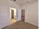 Bedroom with doorways to the bathroom and hallway and neutral carpet at 3577 Conroy Rd # 331, Orlando, FL 32839