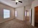 Bright bedroom with neutral carpet, two windows, and an attached closet at 3577 Conroy Rd # 331, Orlando, FL 32839
