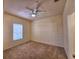 Bedroom featuring neutral carpet, a ceiling fan, and a window overlooking the exterior at 3577 Conroy Rd # 331, Orlando, FL 32839
