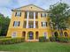 Attractive yellow three-story condo building featuring private balconies, and lush landscaping at 3577 Conroy Rd # 331, Orlando, FL 32839