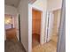 Hallway featuring a closet with built-in shelving, doorways to the bathroom and kitchen at 3577 Conroy Rd # 331, Orlando, FL 32839