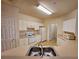 Functional kitchen with white appliances, cabinetry, and sink beneath fluorescent lighting at 3577 Conroy Rd # 331, Orlando, FL 32839