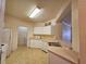 Efficient kitchen with white appliances, countertop, and a pass-through to the dining area at 3577 Conroy Rd # 331, Orlando, FL 32839