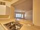 Kitchen featuring a convenient pass-through, sink with stainless faucet, and access to the living room at 3577 Conroy Rd # 331, Orlando, FL 32839