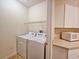 Bright laundry area with a washer, dryer, shelving, and additional storage cabinets and counter space at 3577 Conroy Rd # 331, Orlando, FL 32839
