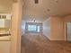 Spacious living room featuring plush carpeting, neutral walls, and natural light from the large window at 3577 Conroy Rd # 331, Orlando, FL 32839