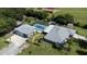 Aerial view of gray home with screened in pool, detached garage, RV parking and spacious lot at 4170 Packard Ave, St Cloud, FL 34772