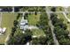 Aerial view of a large property with a screened pool and lush greenery at 4170 Packard Ave, St Cloud, FL 34772