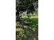 Backyard features a colorful, circular swing hanging from a mature tree, creating a fun outdoor space at 4170 Packard Ave, St Cloud, FL 34772