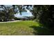 Large grassy backyard view with shade from the nearby tree at 4170 Packard Ave, St Cloud, FL 34772