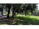 Large backyard featuring a swing set and shady trees, perfect for play and outdoor relaxation at 4170 Packard Ave, St Cloud, FL 34772