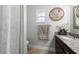 Bathroom features a charming vanity, decorative sign, and a window for natural light at 4170 Packard Ave, St Cloud, FL 34772