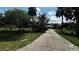Long driveway with green trees on both sides leading to the home at 4170 Packard Ave, St Cloud, FL 34772