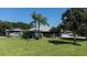 Landscaped yard with charming one-story home, detached garage, and RV parking on a sunny day at 4170 Packard Ave, St Cloud, FL 34772