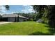 Exterior back of house featuring a large yard and screened in pool at 4170 Packard Ave, St Cloud, FL 34772