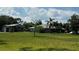 View of the house exterior and garage with a large green lawn at 4170 Packard Ave, St Cloud, FL 34772
