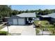 Home featuring RV parking, a two-car garage, and lush landscaping at 4170 Packard Ave, St Cloud, FL 34772
