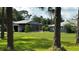 A view of the exterior with a screened-in porch and a detached garage at 4170 Packard Ave, St Cloud, FL 34772