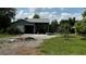 Detached garage featuring an open carport area for parking at 4170 Packard Ave, St Cloud, FL 34772
