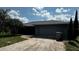 Attached two-car garage featuring new roof, modern design, and spacious driveway at 4170 Packard Ave, St Cloud, FL 34772