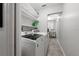 Well-organized laundry room with modern appliances and ample shelving for storage at 4170 Packard Ave, St Cloud, FL 34772