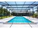 Screened in swimming pool with ladder and exterior view of home at 4170 Packard Ave, St Cloud, FL 34772