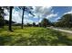 Spacious grassy yard with a partial view of the home and detached garage at 4170 Packard Ave, St Cloud, FL 34772