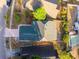 Aerial view of a neatly maintained home with a gray roof, surrounded by lush landscaping and neighboring houses at 4232 Sandhurst Dr, Orlando, FL 32817