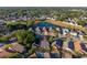 Aerial view featuring a house in a residential area with a pond and lush green trees surrounding the neighborhood at 4232 Sandhurst Dr, Orlando, FL 32817