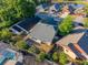 Aerial view showcasing a well-maintained home with fenced yard and view of community pond at 4232 Sandhurst Dr, Orlando, FL 32817
