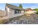 View of the backyard and back of the house featuring white wooden fence at 4232 Sandhurst Dr, Orlando, FL 32817