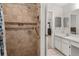 Tiled walk-in shower featuring grab bars and a shower head at 4232 Sandhurst Dr, Orlando, FL 32817