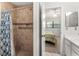 Tiled shower with grab bars and shower curtain next to the bedroom at 4232 Sandhurst Dr, Orlando, FL 32817