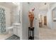 Neat bathroom in the hall with a shower and bathtub adjacent to an elegant table arrangement at 4232 Sandhurst Dr, Orlando, FL 32817
