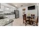 Cozy kitchen breakfast nook with granite counters, stainless appliances, and a view of the backyard at 4232 Sandhurst Dr, Orlando, FL 32817