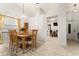 Open-concept dining area featuring a table for six and adjacent breakfast nook with plenty of natural light at 4232 Sandhurst Dr, Orlando, FL 32817
