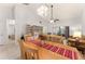 Open-concept dining area featuring a large table for six, flowing seamlessly into the living space with natural light at 4232 Sandhurst Dr, Orlando, FL 32817