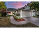 Charming single-story home featuring a well-manicured lawn, complemented by tasteful landscaping and a two-car garage at 4232 Sandhurst Dr, Orlando, FL 32817