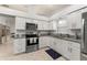 Modern kitchen with white cabinets, stainless steel appliances, and granite countertops, a chef's delight at 4232 Sandhurst Dr, Orlando, FL 32817