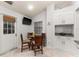 Eat-in kitchen area featuring a breakfast table with seating and built-in white cabinets at 4232 Sandhurst Dr, Orlando, FL 32817