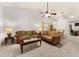 Spacious living room with warm lighting, comfortable sofas, and tile flooring creates an inviting atmosphere at 4232 Sandhurst Dr, Orlando, FL 32817