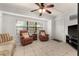 Cozy living room with comfortable seating, natural light, and ceiling fan at 4232 Sandhurst Dr, Orlando, FL 32817