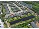 An aerial view of a planned community showcases the neighborhood with homes surrounding a pond at 4548 Dulwik Pl, Sanford, FL 32771