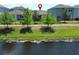 Aerial view of backyard with pond and surrounding homes, marked with a red pin at 4548 Dulwik Pl, Sanford, FL 32771